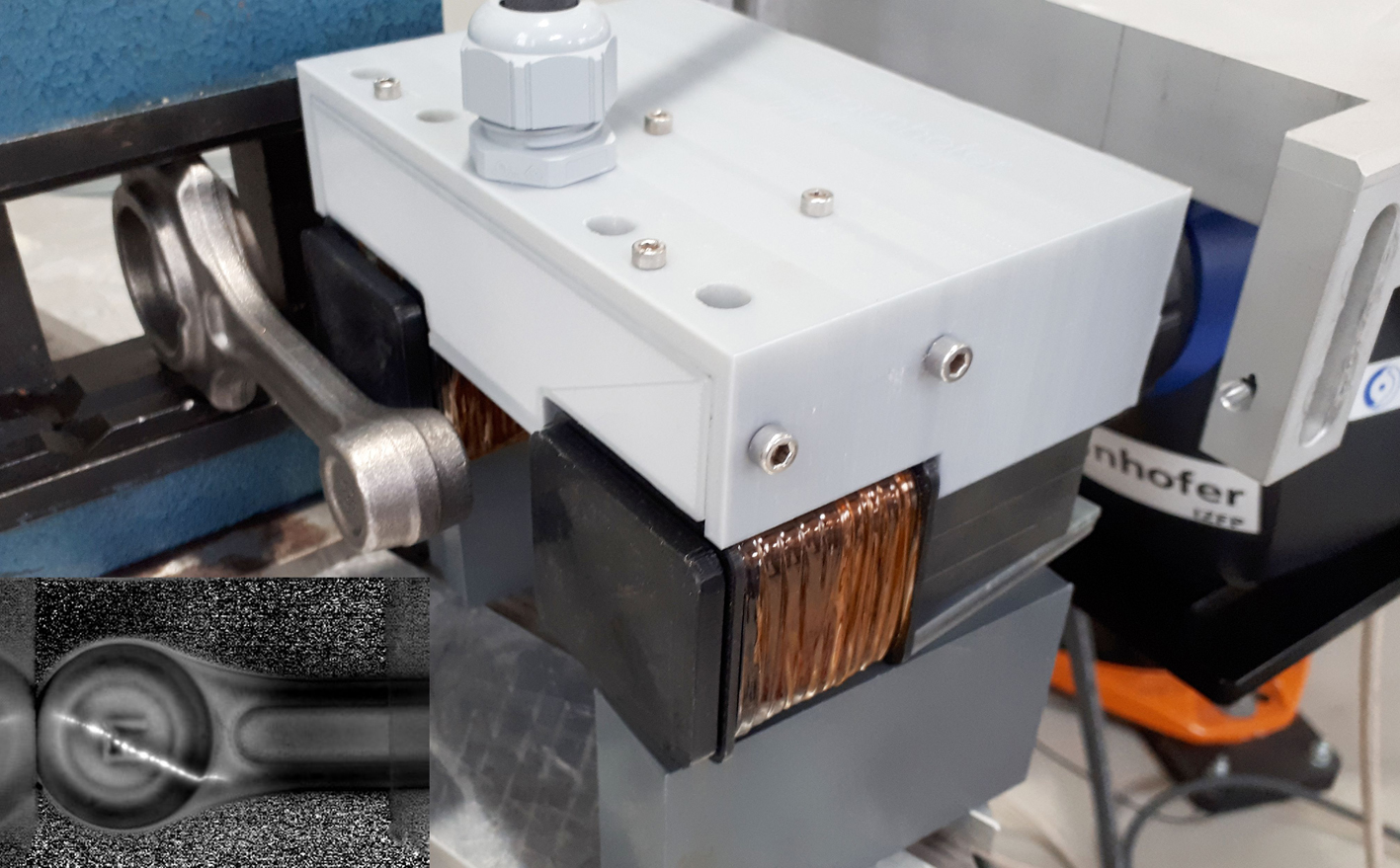 Inspection head for automated detection of surface defects in forged steel parts. Inset bottom left: Thermographic indication of a crack. 